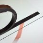 Magnetic self-adhesive sign strip for converting non-magnetic signs into magnetic signs