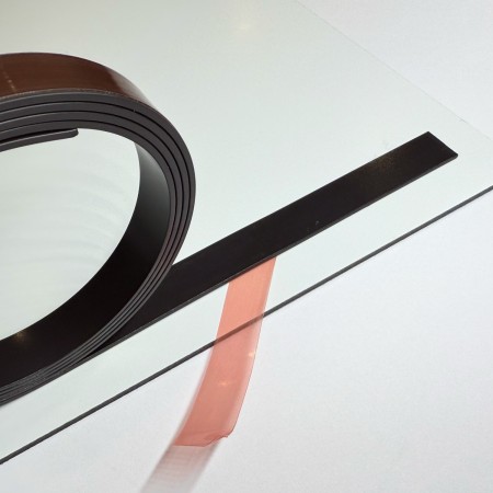 Magnetic self-adhesive sign strip for converting non-magnetic signs into magnetic signs