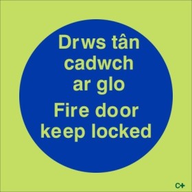 Glow in the dark Fire Door Keep Locked sign in Welsh and English