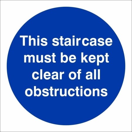 This Staircase Must Be Kept Clear Of All Obstructions mandatory sign with white text on a blue circular background