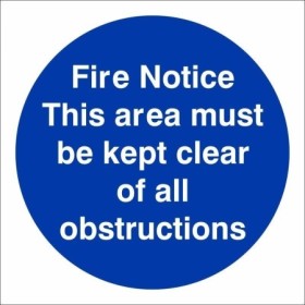 Fire Notice This Area Must Be Kept Clear Of All Obstructions mandatory sign with white text on a blue circular background