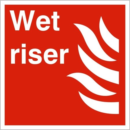 Wet Riser Symbol Sign with white text and flame symbol on red background